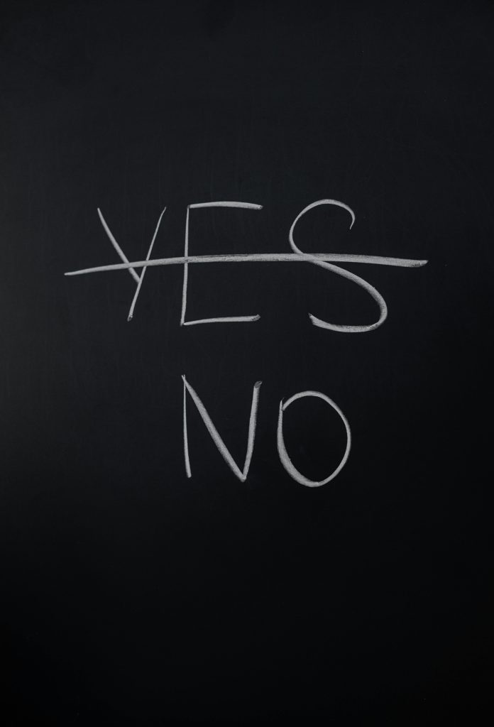 pexels-photo-3825295-3825295 Handwritten chalk decision concept with 'yes' crossed out and 'no' emphasized.